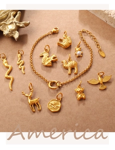 Macro shot of 3D animal charms and gold-plated stainless steel bracelet with engraving
