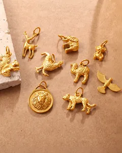 Macro view of detailed golden animal charms including bear and lion with polished finish