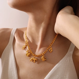 Artistic golden necklace featuring multiple 3D animal charms like squirrel and elephant