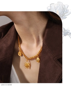 Detail von Vintage-Goldanhängern mit Sonne und Mond an einer schicken Gliederkette