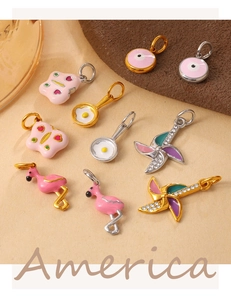 Detailed close-up of colorful enamel charms featuring flamingo and evil eye patterns