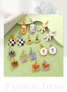Detailed close-up of colorful enamel charms like castle and camera for DIY jewelry
