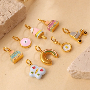 Set of 8 colorful enamel pendants including camera and evil eye on beige texture background