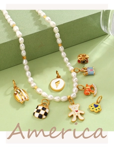 Detail of pearl necklace with colorful enamel charms including bear, castle and hobby horse
