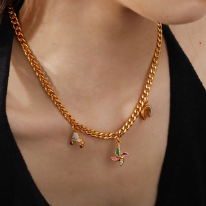 Golden Cuban chain necklace with colorful enamel roller skate and windmill pendants