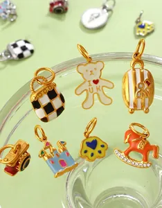 Detailed view of colorful enamel charms with castle, bear and camera shapes for DIY jewelry