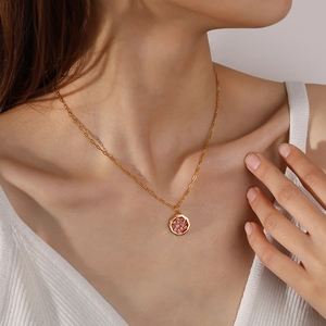 Collier en chaîne dorée avec pendentif pizza coloré porté par un modèle en haut blanc