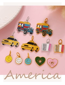 Macro view of colorful enamel taxi and smiley face charms with fine metal finish