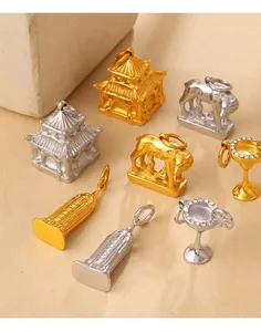 Detailed view of 18K gold and silver charms including Eiffel Tower and roman leopard