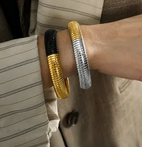 Detail of 12mm elastic snake bone bracelets in two-tone gold and silver finishes