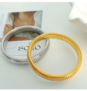 Detail view of gold and silver Tubogas snake bone stretch bracelets on display