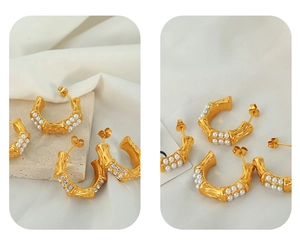 Macro view showing bamboo texture and pearl detailing on gold C-shaped earrings