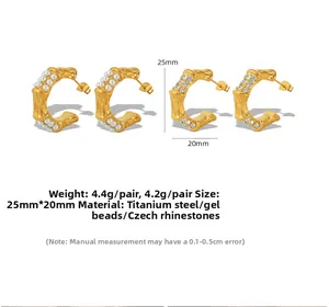 Detailed view of bamboo style C-shape titanium steel earrings with pearls and crystals