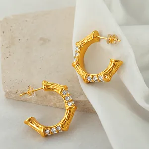 Vintage gold bamboo C-shaped earrings with sparkling diamonds and pearls on stone