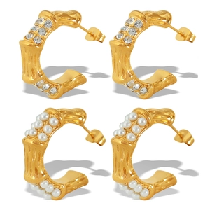 Bamboo style C-shaped gold hoop earrings with sparkling cubic zirconia and faux pearls
