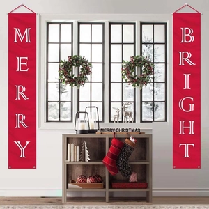 Close-up of festive red Merry and Bright Christmas banners hanging by a white window