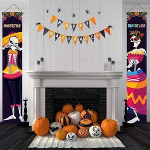 Vertical Day of the Dead banners with skull designs displayed by a cozy white fireplace