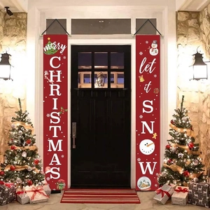 Detail of Christmas banners with Merry Christmas and Let it Snow on red polyester fabric