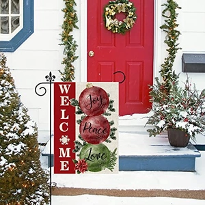 Christmas garden flag featuring festive ornaments on a snow-covered porch display