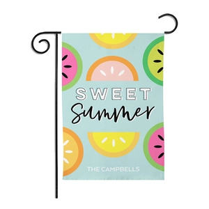 Detail of garden flag with sweet summer fruit patterns and black metal hanging stand