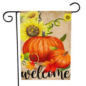 Detail of harvest garden flag showing sunflower, pumpkins, and welcome text on burlap