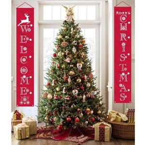 Vertical red Merry Christmas and Welcome banners on porch with a decorated tree