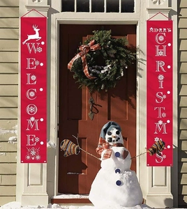 Outdoor Christmas door banners with Merry Christmas text displayed on a front porch