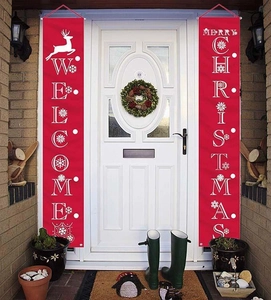 Outdoor Christmas porch banners featuring reindeer and Merry Christmas text on a white door