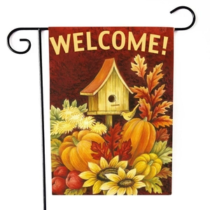 Detail of harvest garden flag with pumpkins, sunflowers and birdhouse on a metal stand