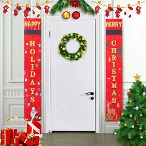 Detailed view of red Christmas door banners with Santa Claus and reindeer on a white door