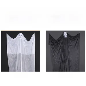 Detail showing white and black gauze hanging ghosts with skull heads for Halloween decor