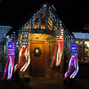 Detail of four LED American flag windsocks with stars and stripes hanging on a wooden porch