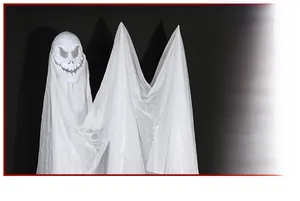 Detail of hanging ghost mask with white mesh fabric for spooky Halloween party decor