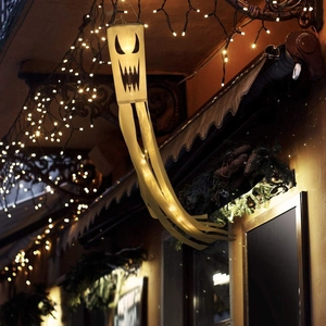 Detail of hanging glowing Halloween ghost windsock with warm white LED lights for party
