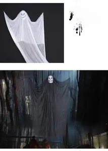 Close-up of white and black ghost hanging decorations with skull masks for Halloween party