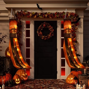 Close-up of LED glowing Halloween pumpkin windsocks hanging on a porch with festive lights