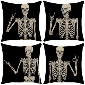 Set of four black Halloween throw pillows with beige skeleton hands showing gestures