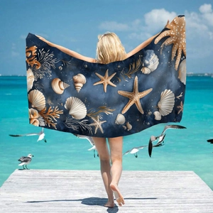 Blue microfiber beach towel with realistic shell and starfish print by the sea