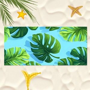 Green monstera leaf microfiber beach towel with tropical blue background and starfish décor