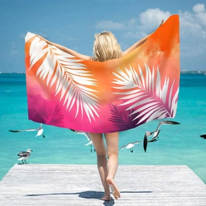 Microfiber beach towel with colorful palm leaf print worn as a summer wrap on a sunny dock
