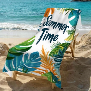 Detail of microfiber beach towel with tropical leaves and Summer Time text on a beach lounger
