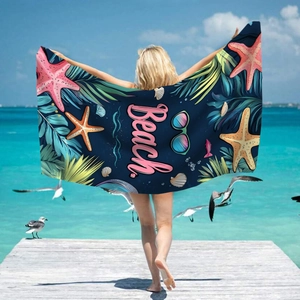 Microfiber beach towel with starfish print and palm leaves on deep blue sea background