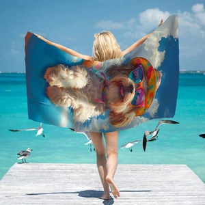 Microfiber beach towel with cool cartoon dog print held by a model on a sunny pier