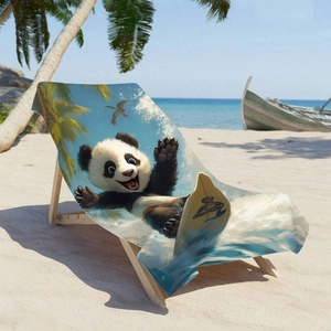 Microfiber beach towel with surfing panda print displayed on a sun lounger at a tropical beach