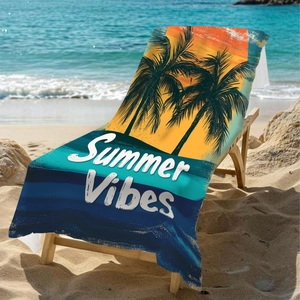 Microfiber beach towel with sunset palm trees and Summer Vibes print on a lounger