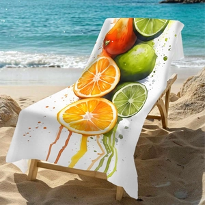 Microfiber beach towel with watercolor citrus print on a wooden chair by the blue ocean