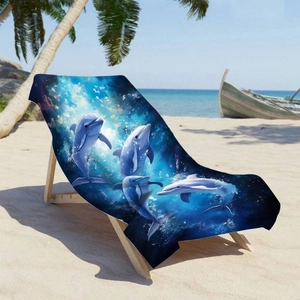 Microfiber beach towel with deep blue ocean dolphin print on a tropical sun lounger