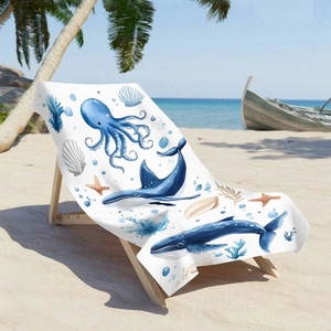 Microfiber beach towel featuring blue octopus and whale print on a wooden sand chair
