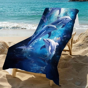 Microfiber beach towel with 3D dolphin ocean print resting on a chair by the blue sea