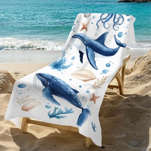 Microfiber beach towel with watercolor whale and sea stars design on a wooden chair